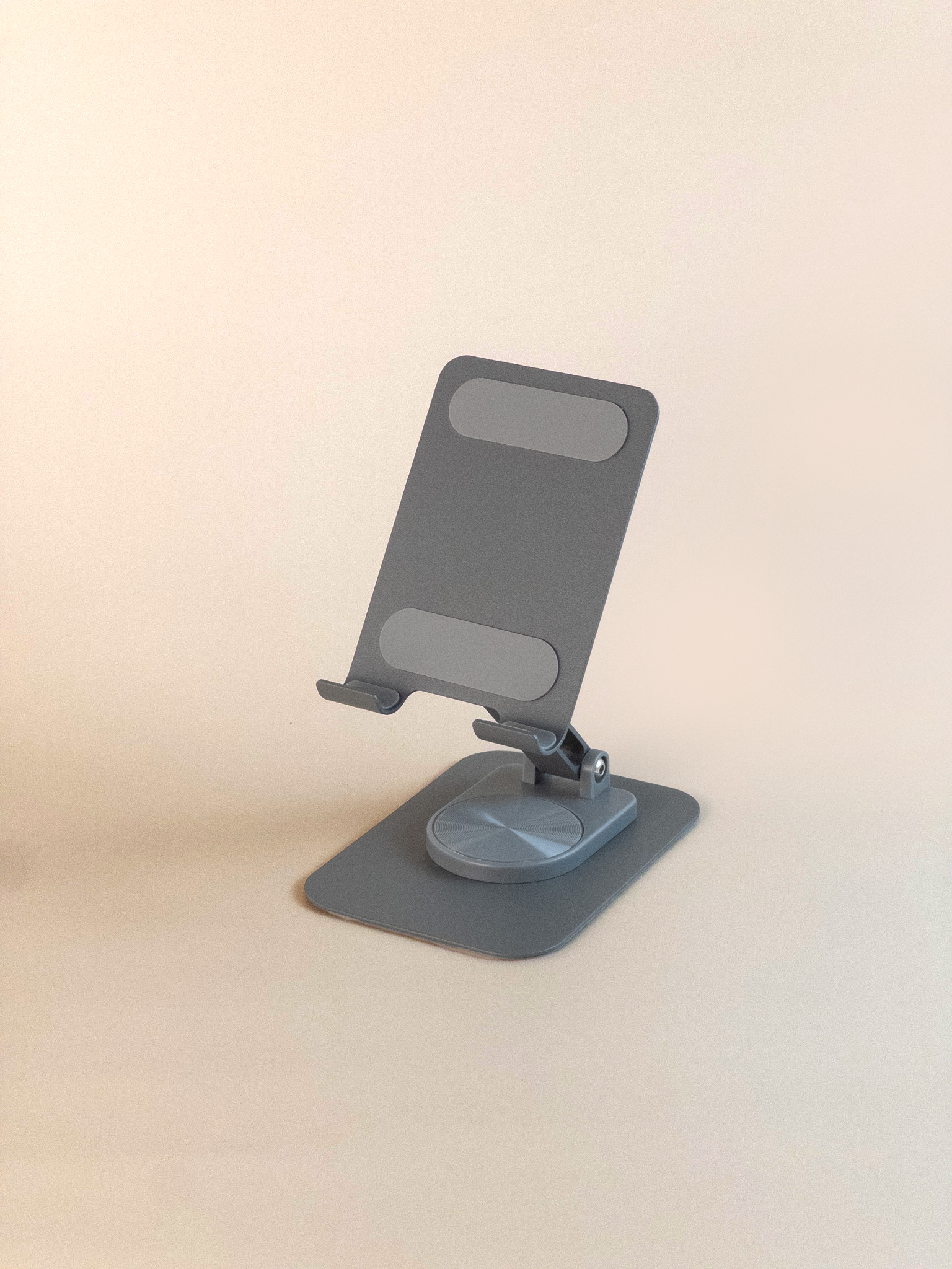 Gray phone stand on a beige background