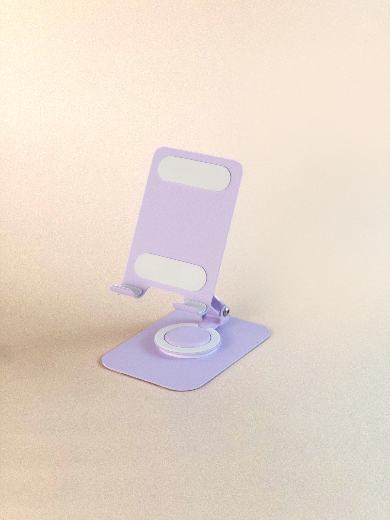 Light purple phone stand on a beige background