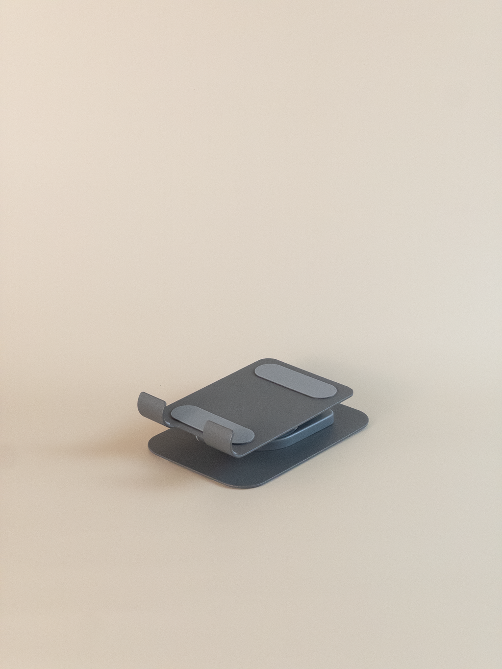 collapsed phone stand on a beige background