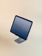 ipad on a stand with a beige background