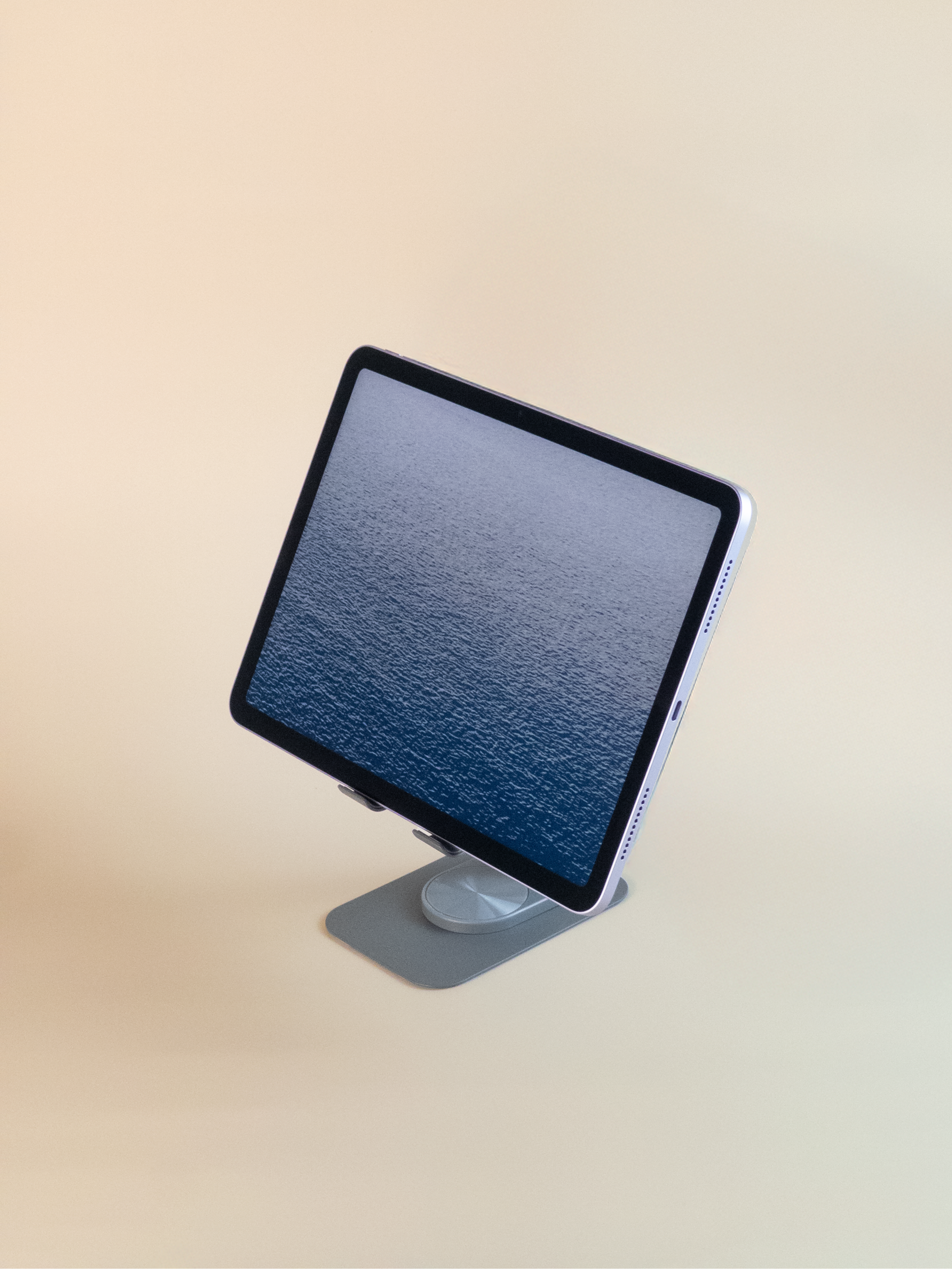 ipad on a stand with a beige background