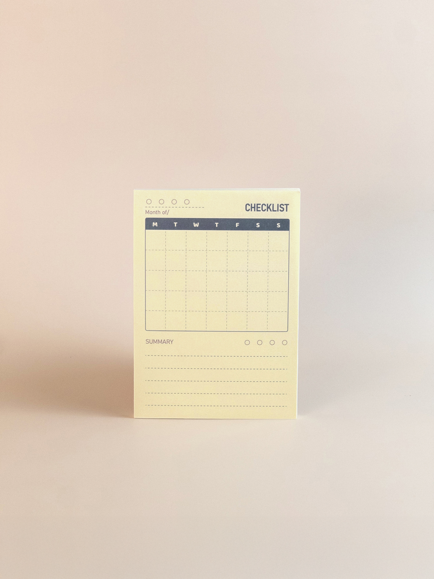 Yellow checklist notepad on a beige background