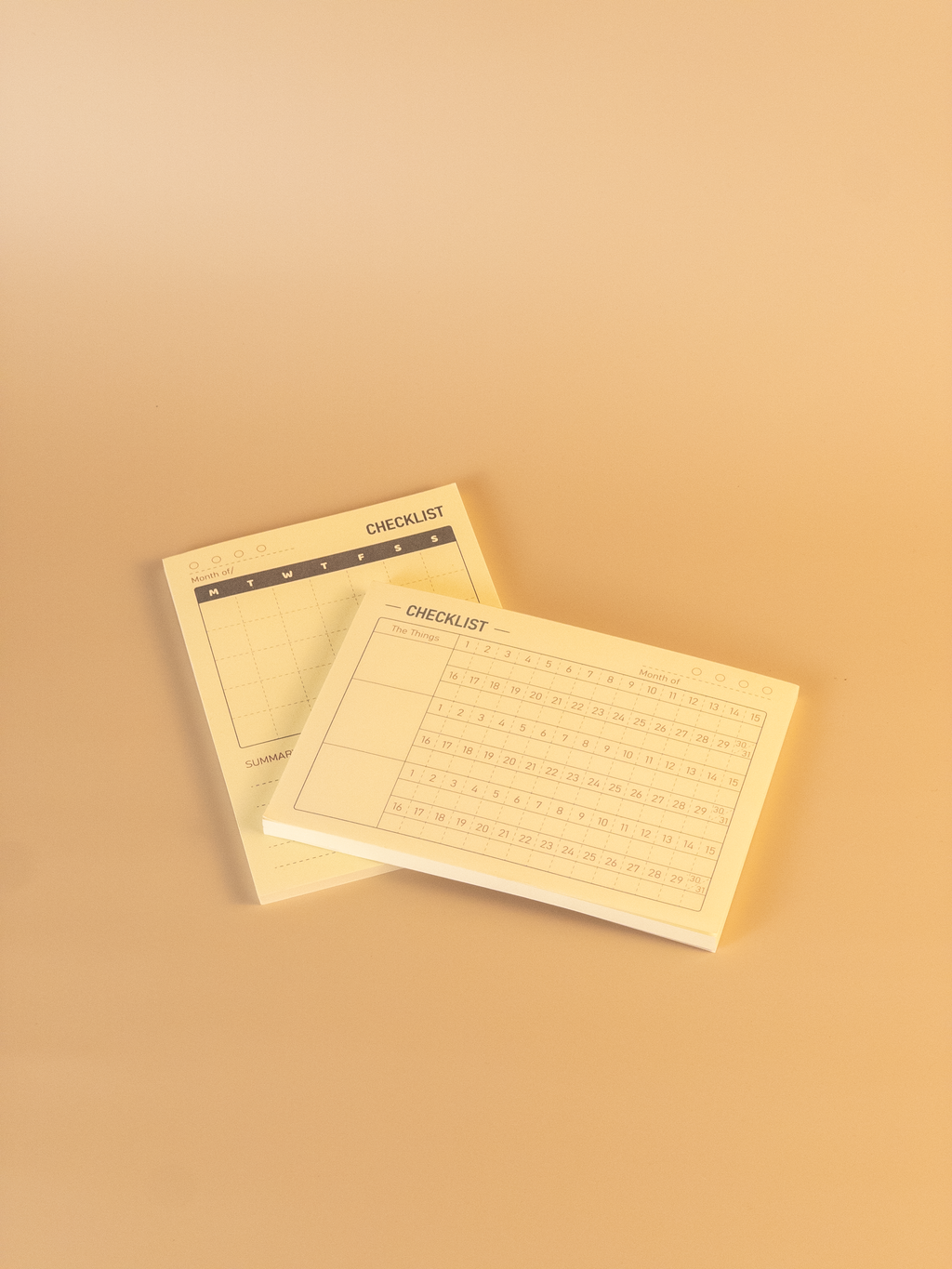 Two beige checklists on a matching beige background