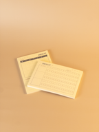 Two beige checklists on a matching beige background