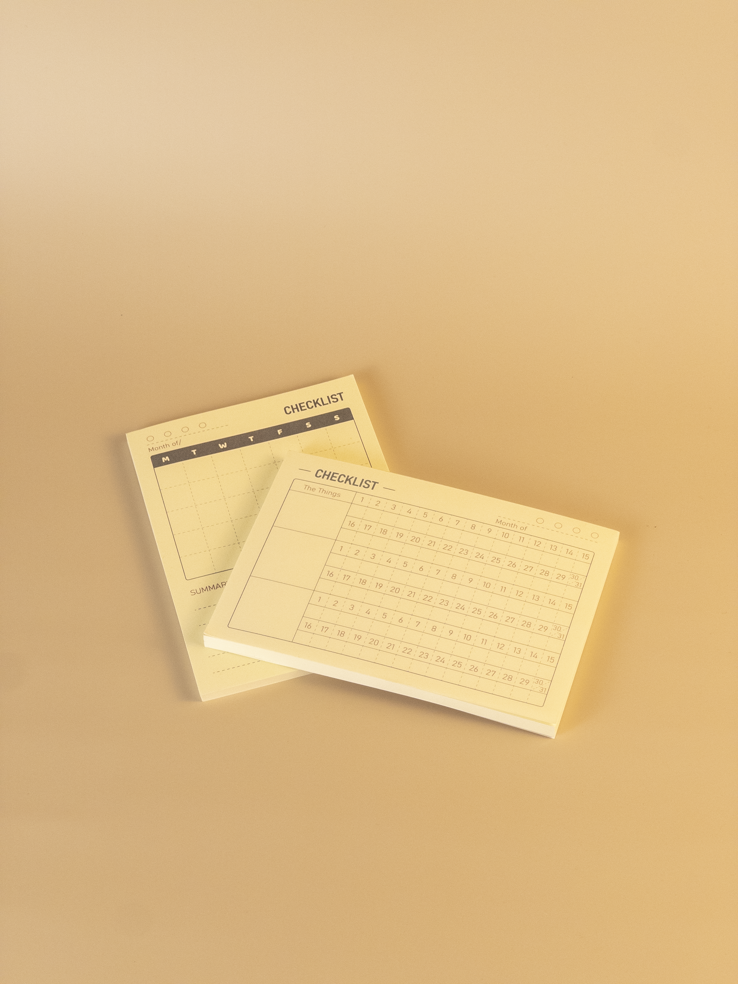 Two beige checklists on a matching beige background