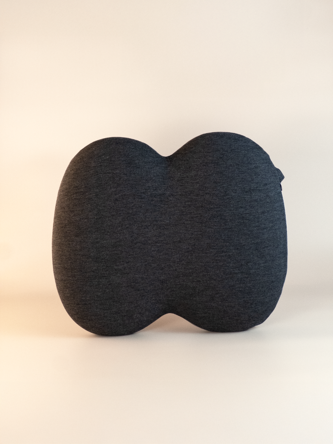 Black pillow seat on a light beige background