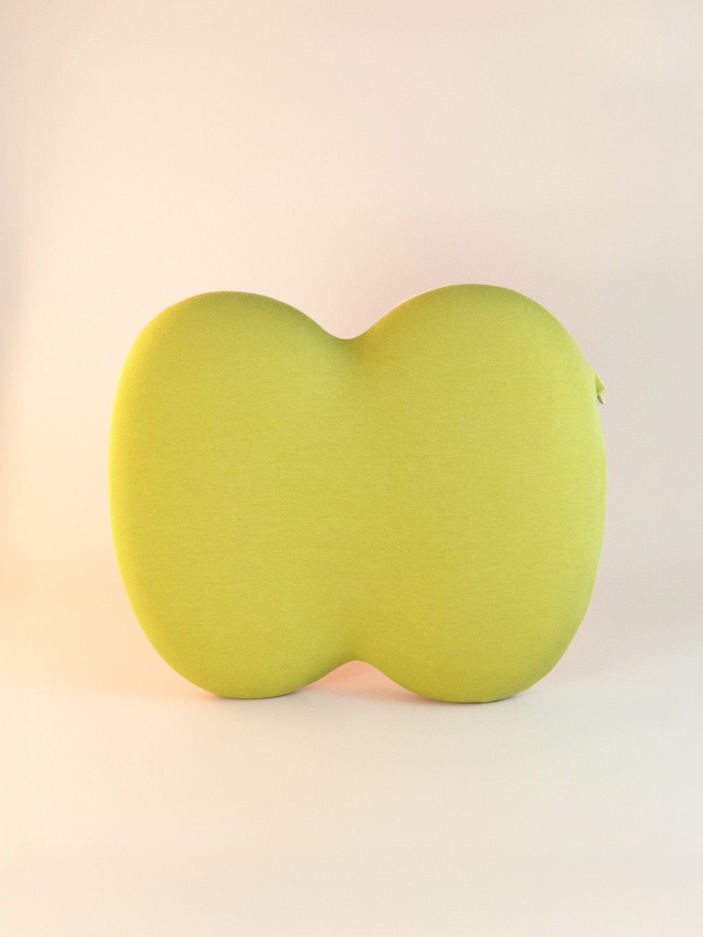 Green pillow seat on a light beige background