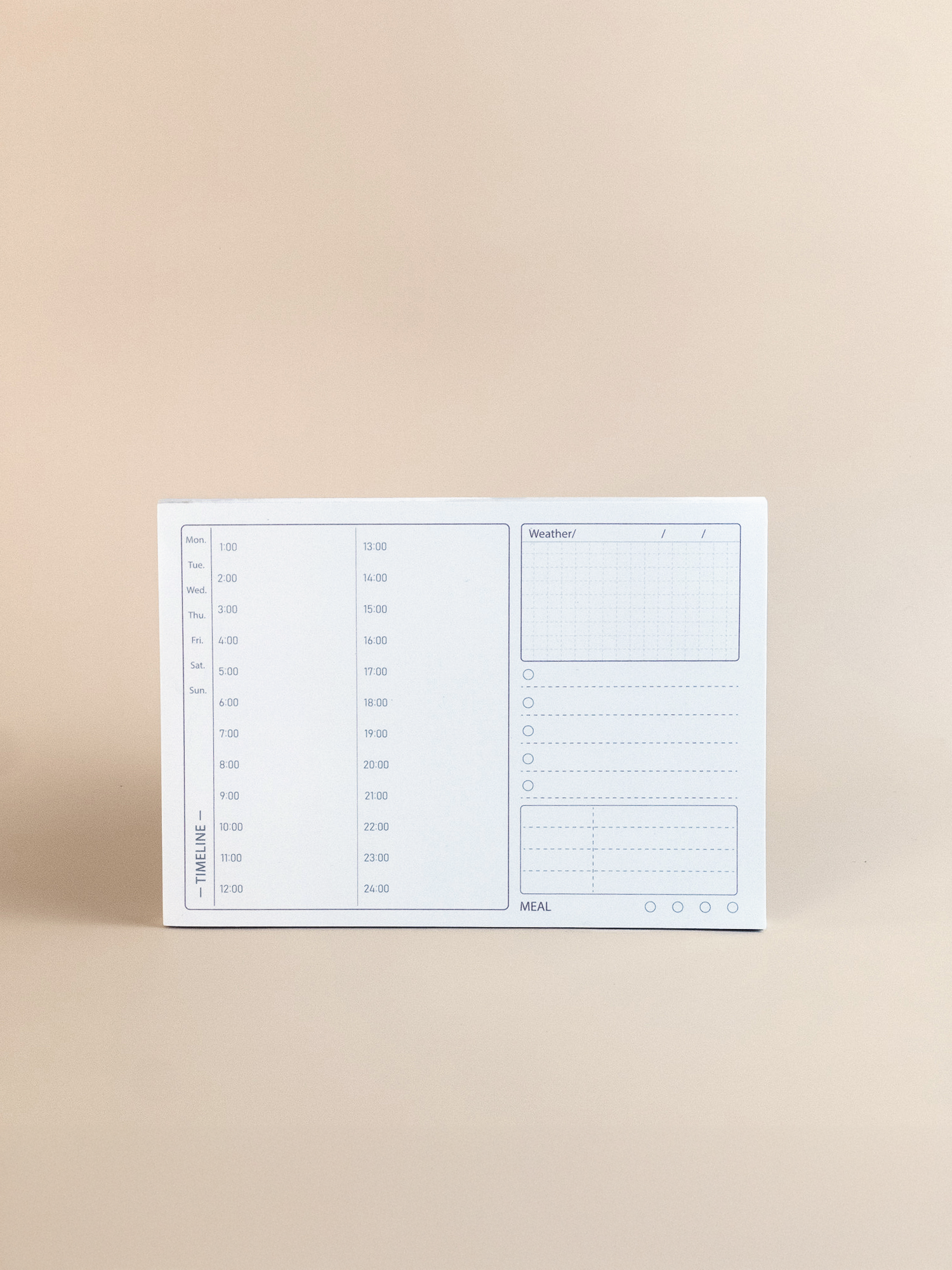 White planner with time slots on a beige background