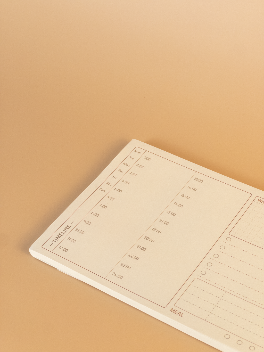 Notebook with a timeline planning layout on a beige background
