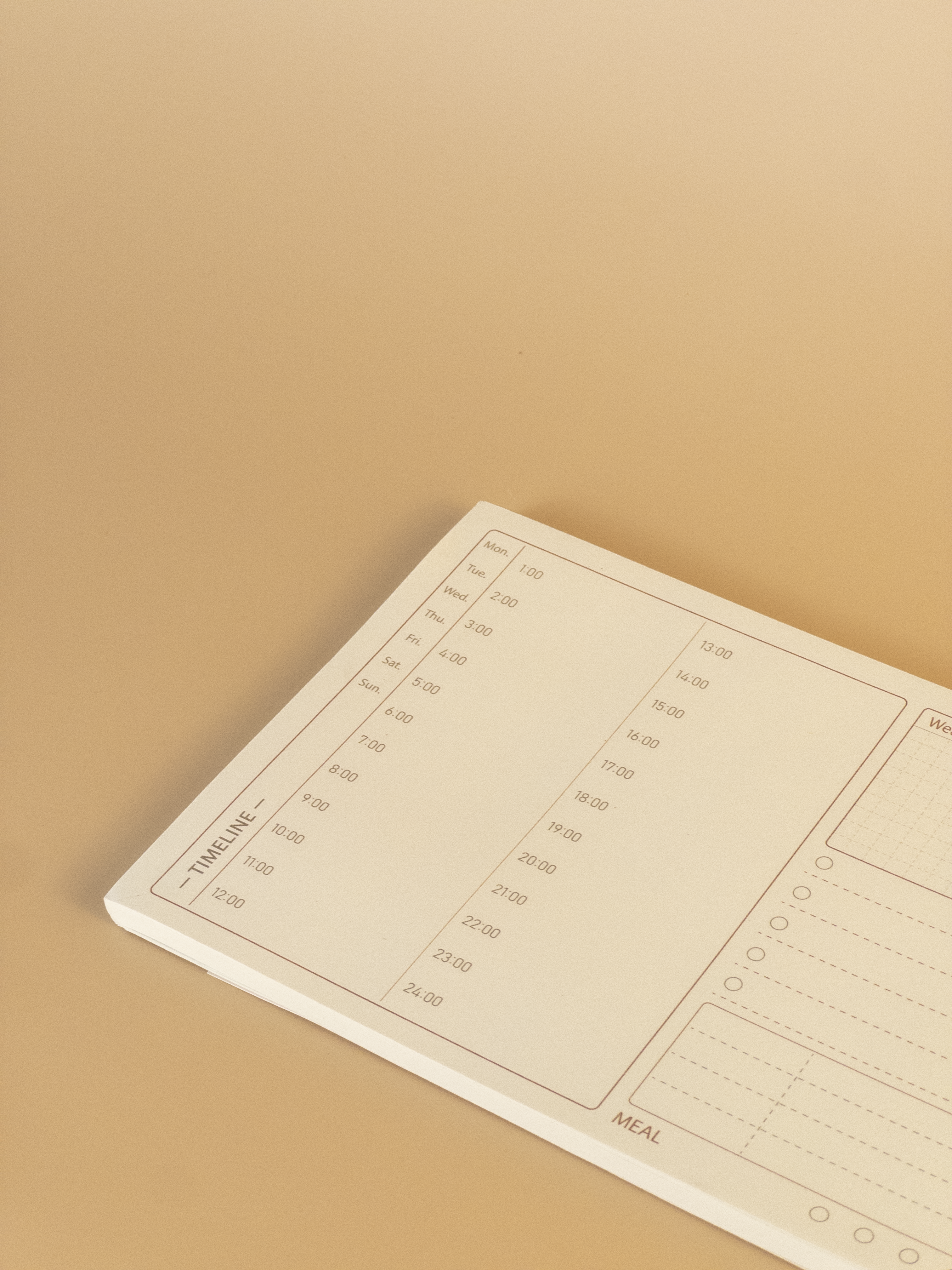 Notebook with a timeline planning layout on a beige background