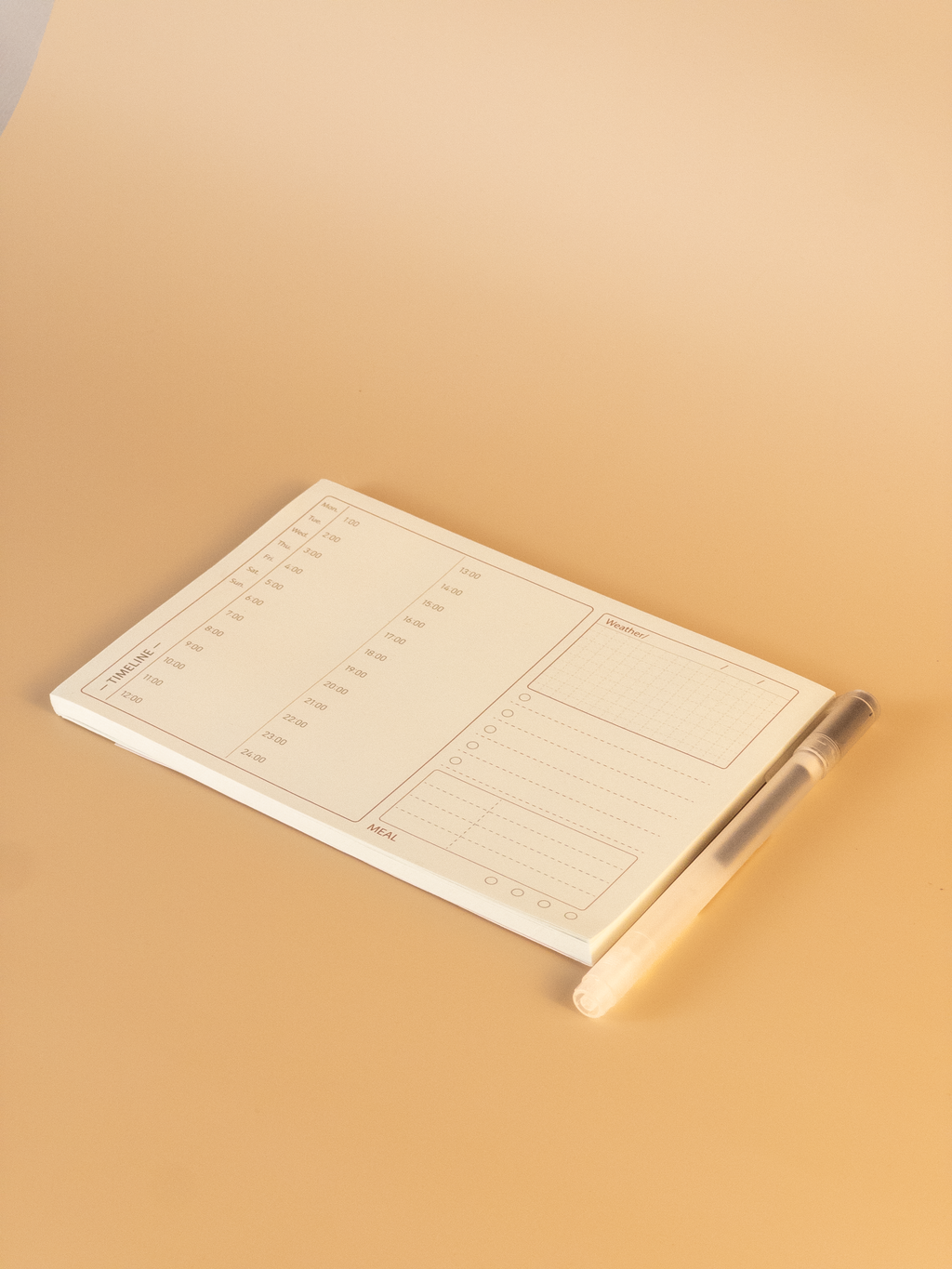 Notebook with a pen on a beige background
