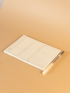 Notebook with a pen on a beige background