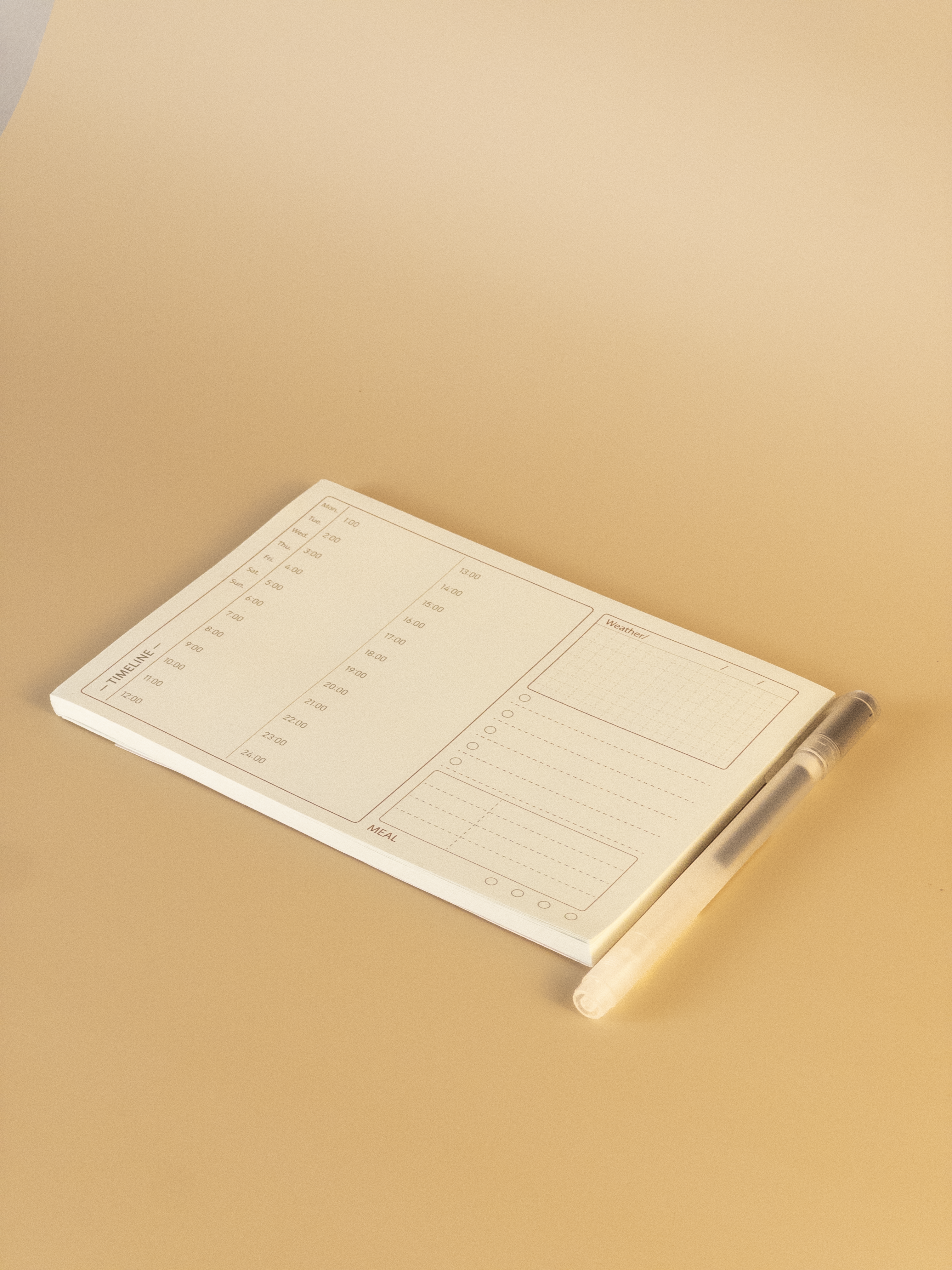 Notebook with a pen on a beige background