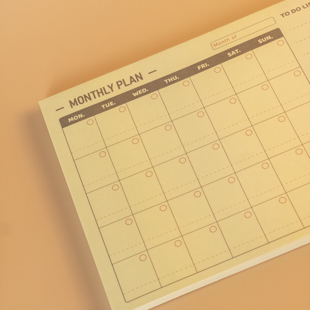 Minimalist design monthly plan calendar notepad on a beige background
