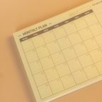 Minimalist design monthly plan calendar notepad on a beige background