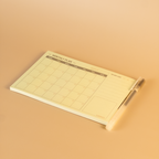 Notebook with grid layout on a beige background
