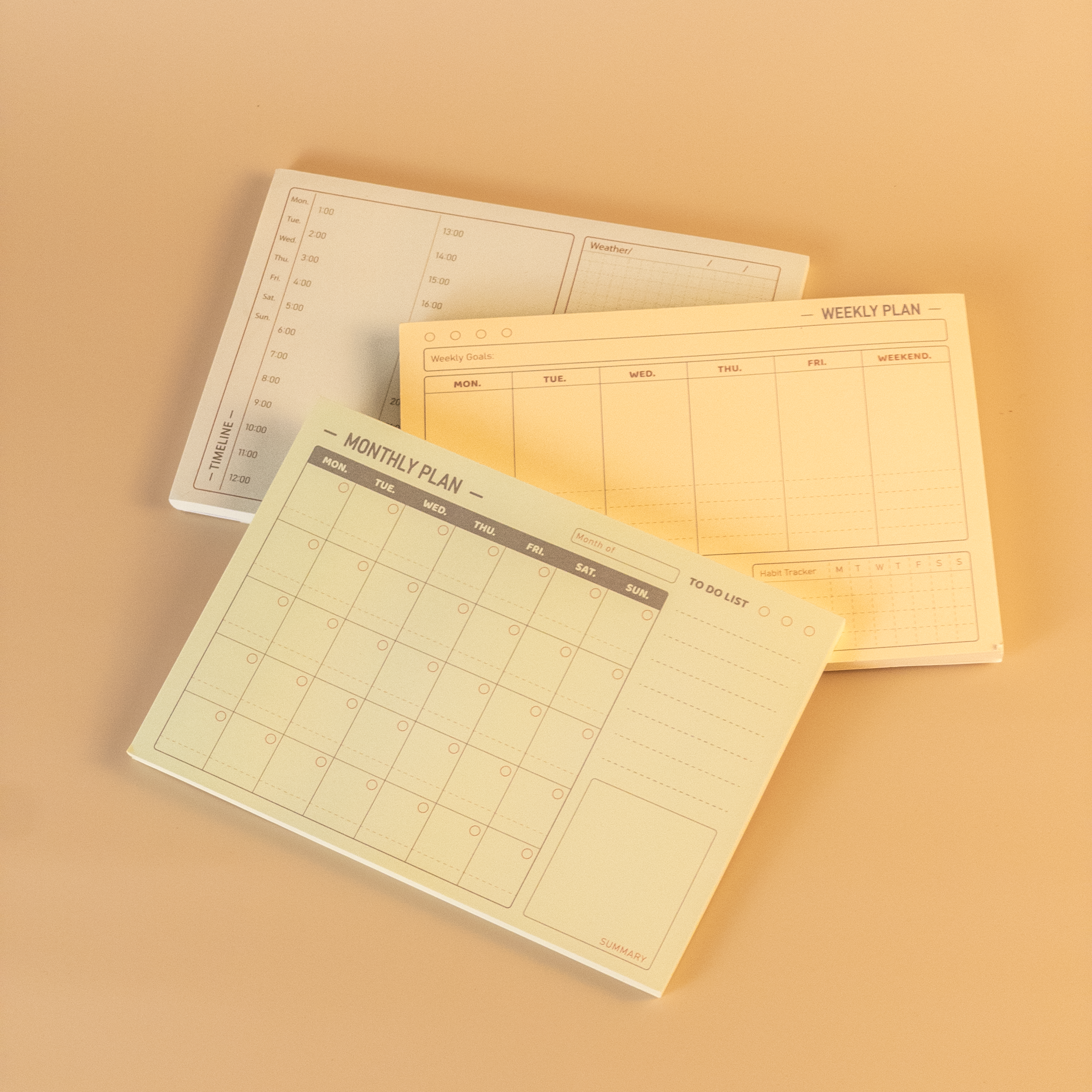 Three planner sheets with different schedules on a beige background
