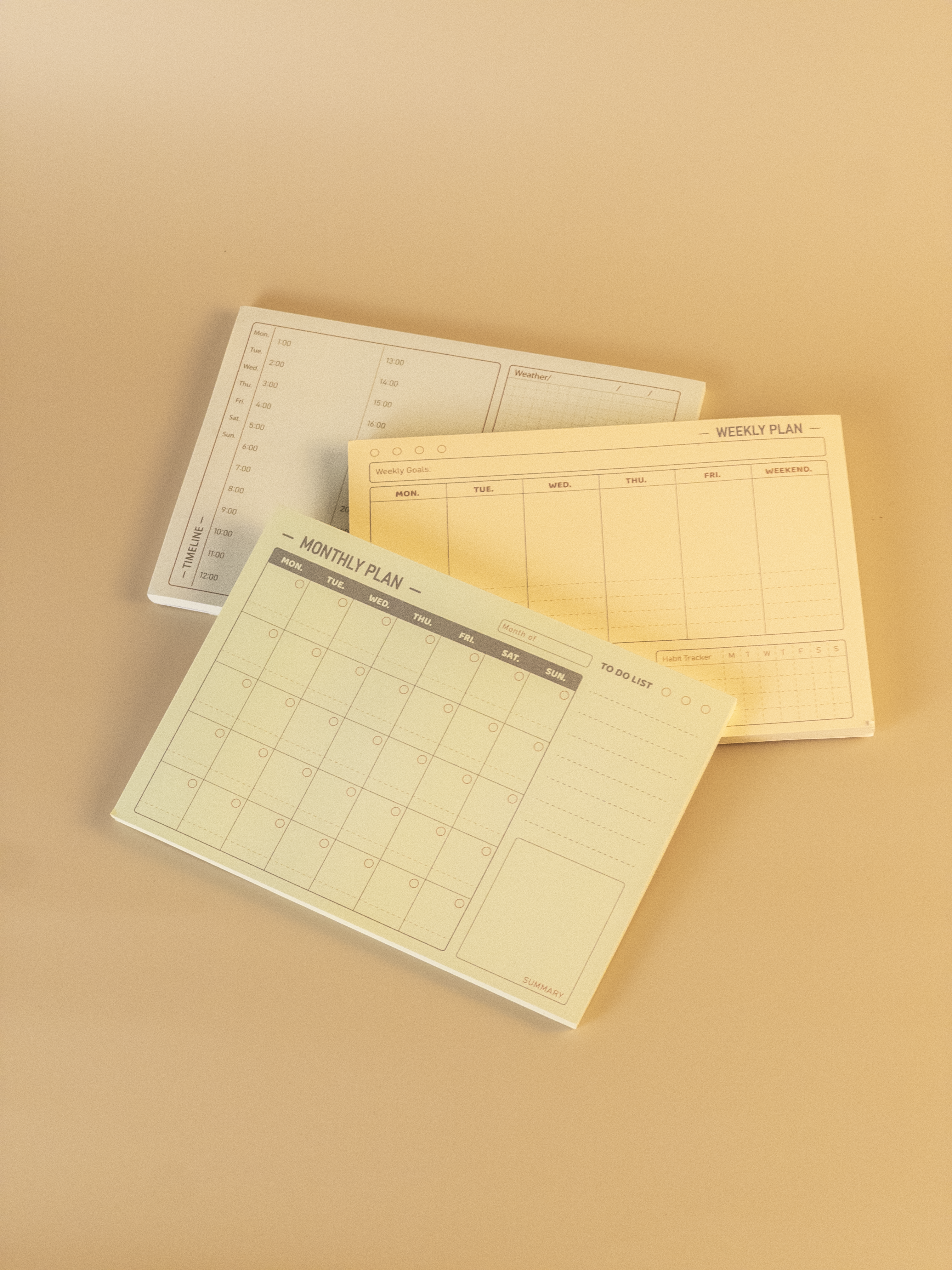 Three planner sheets with different schedules on a beige background
