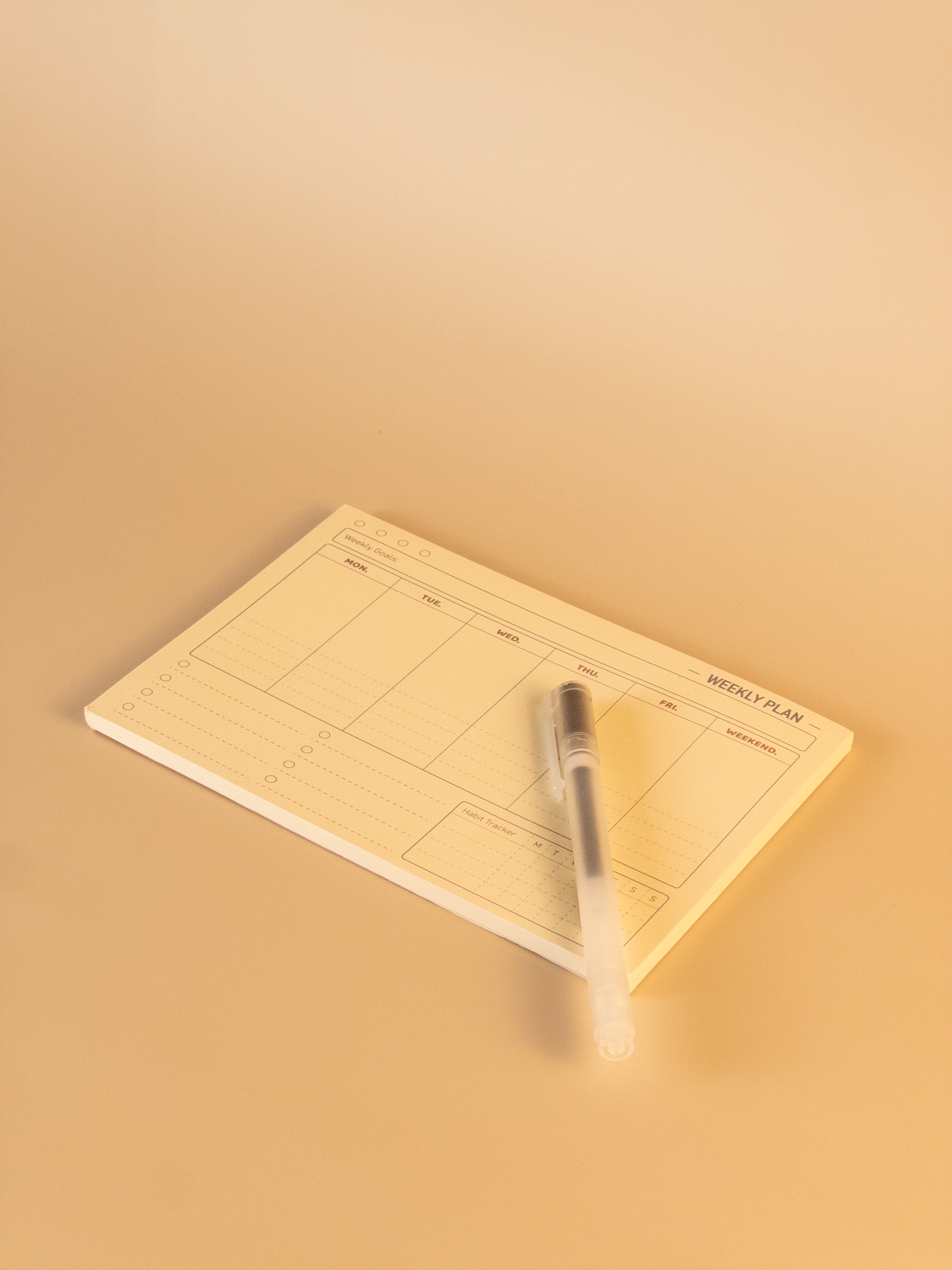 Notebook with pen on a warm beige background