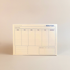 Weekly plan pad on a beige background