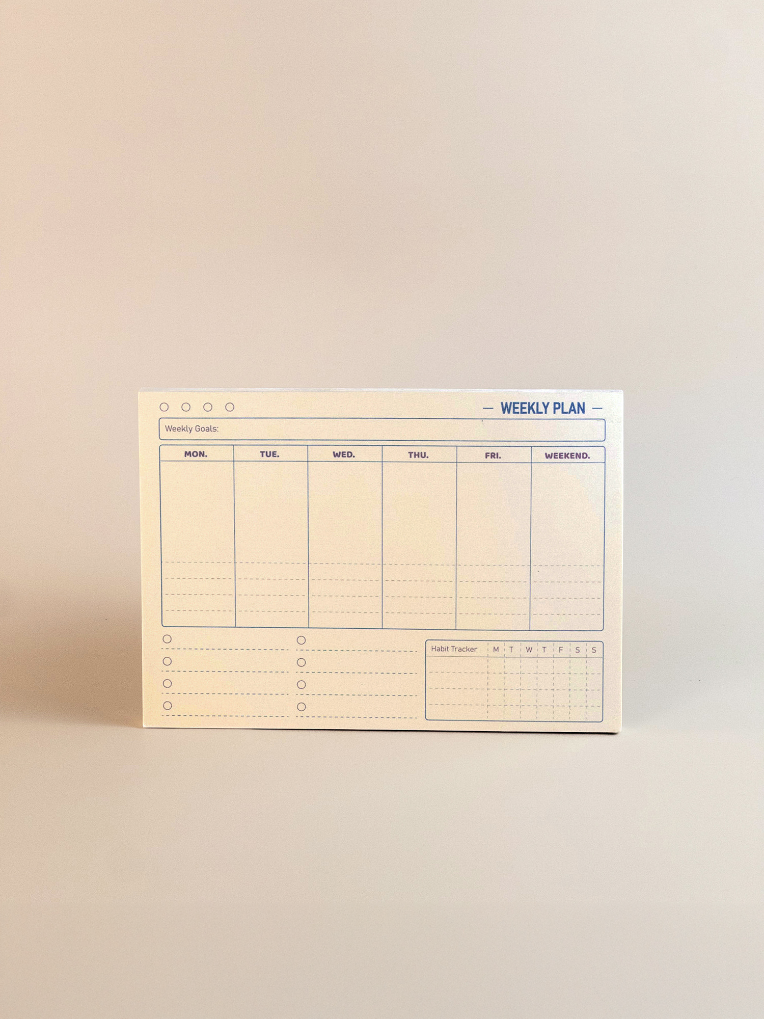 Weekly plan pad on a beige background