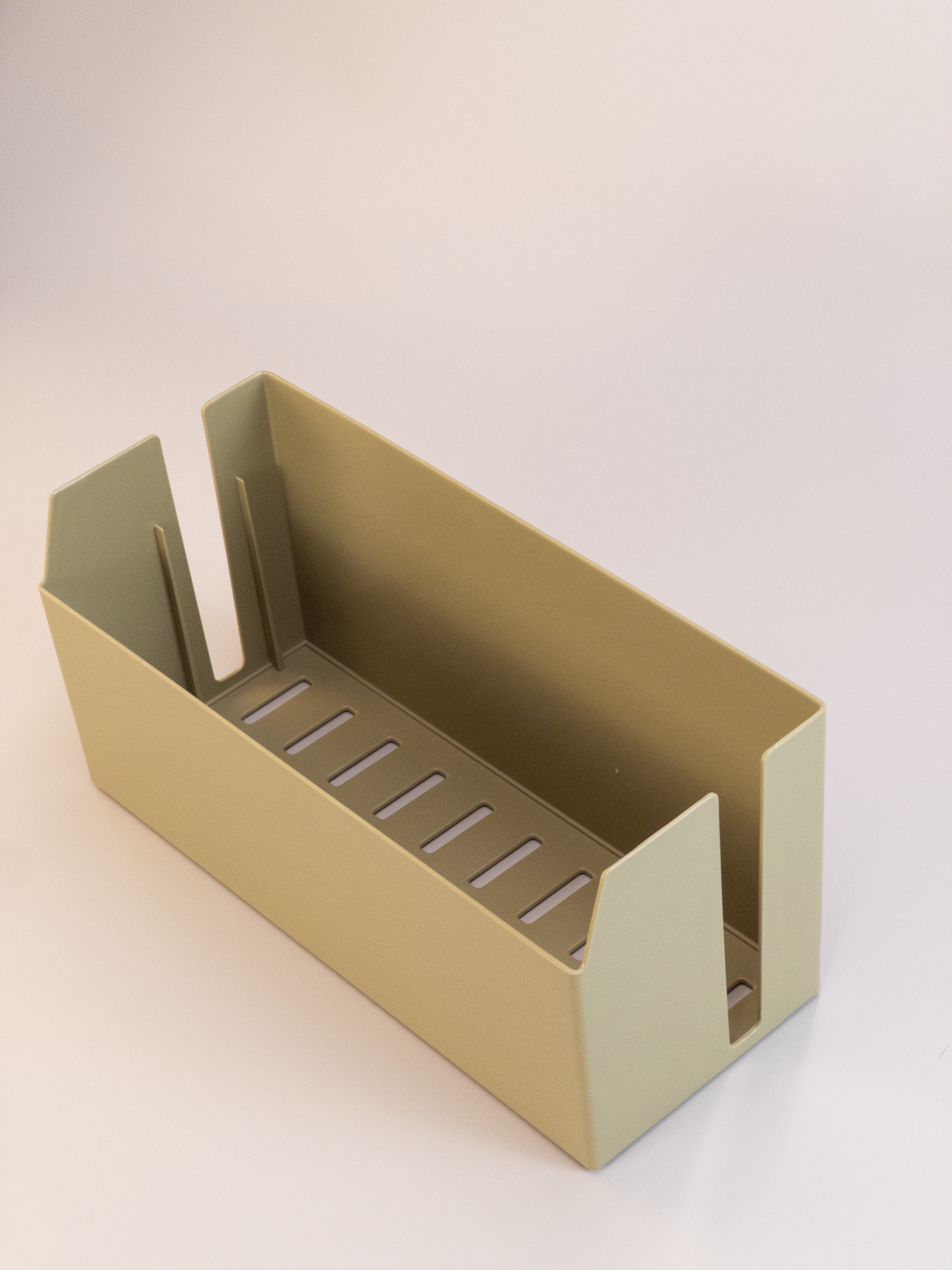 Beige metal tool holder on a white background