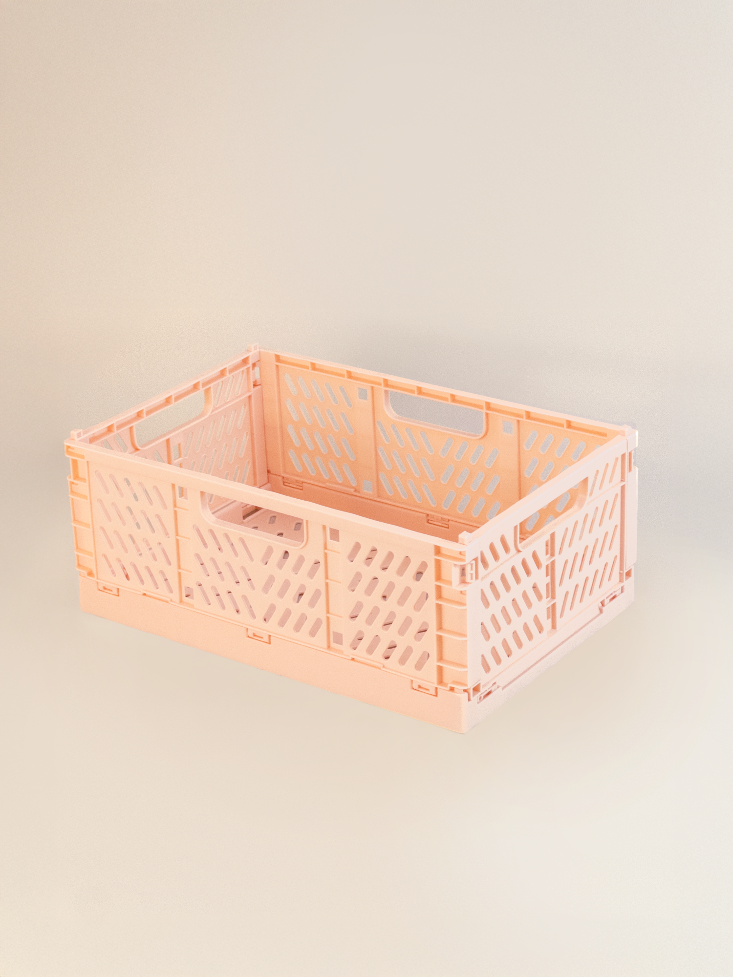 Large pink storage crate on a beige background