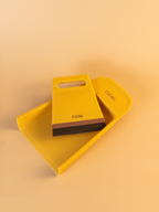 Yellow dustpan and brush set with 'Clean' text on a beige background
