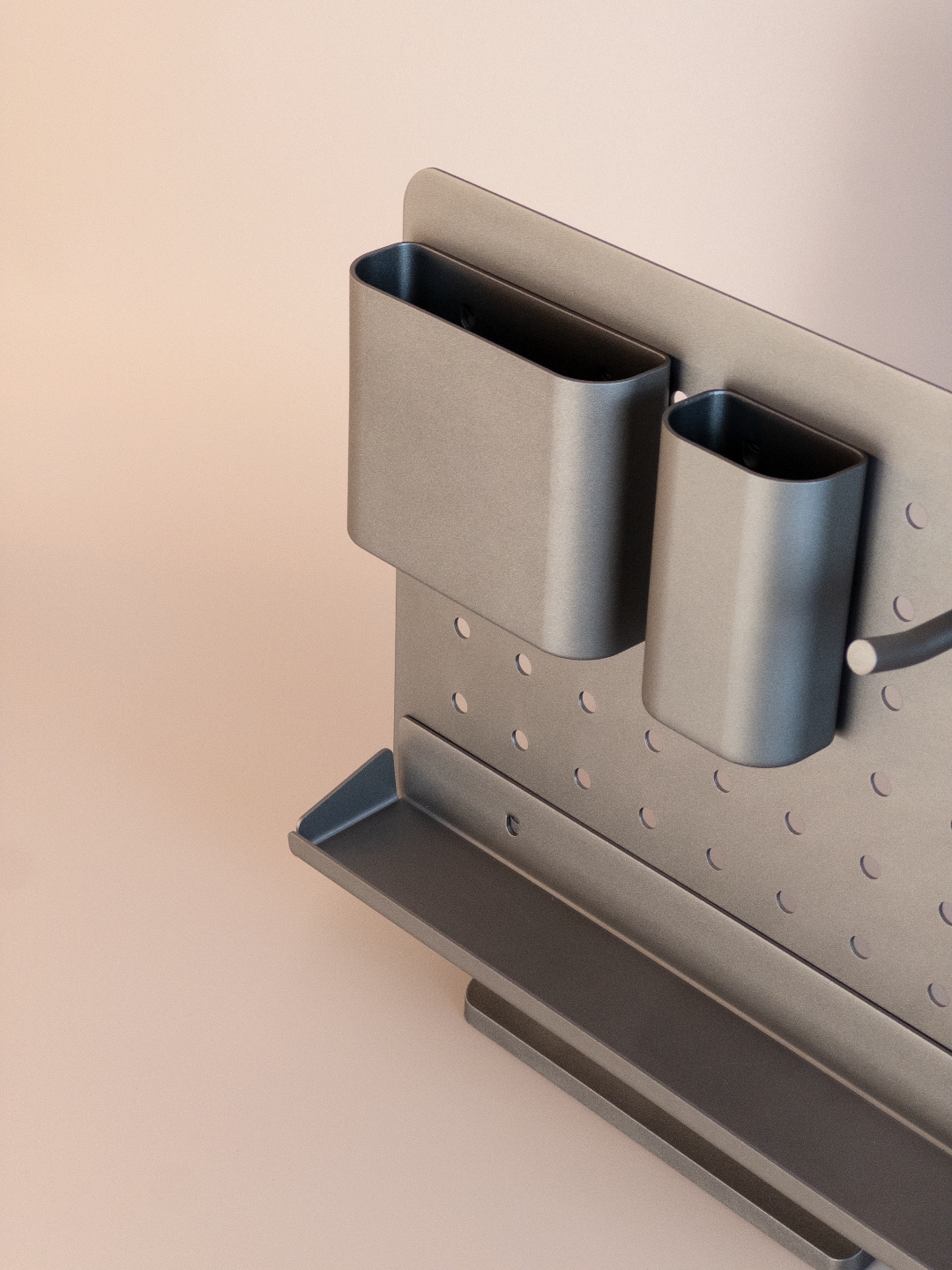 Two gray metal containers attached to a pegboard wall.