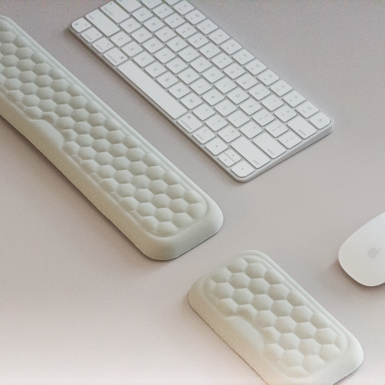 White keyboard, mouse, and wrist rest on a light gray surface