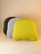 Three ergonomic back support cushions in black, gray, and green on a beige background