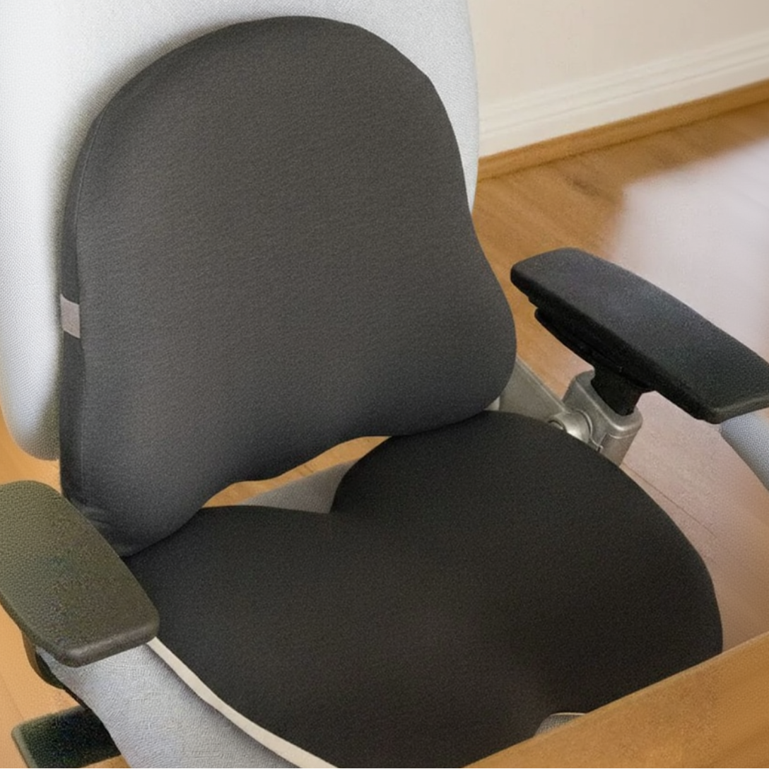 Ergonomic office chair with adjustable armrests on a wooden floor.