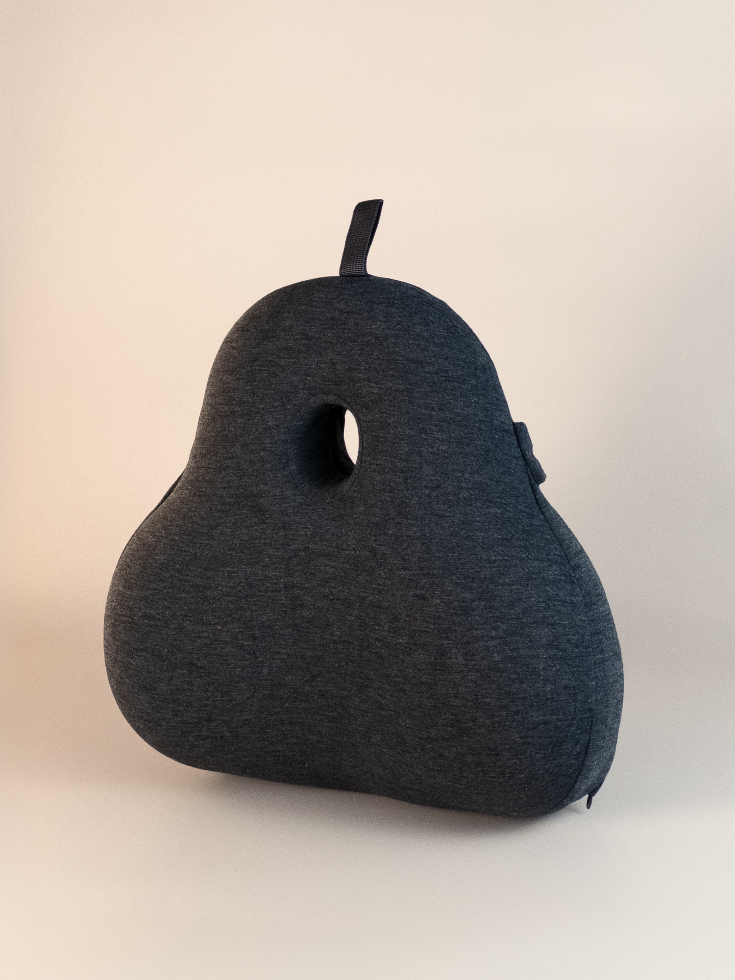 Gray pear-shaped back pillow on a beige background