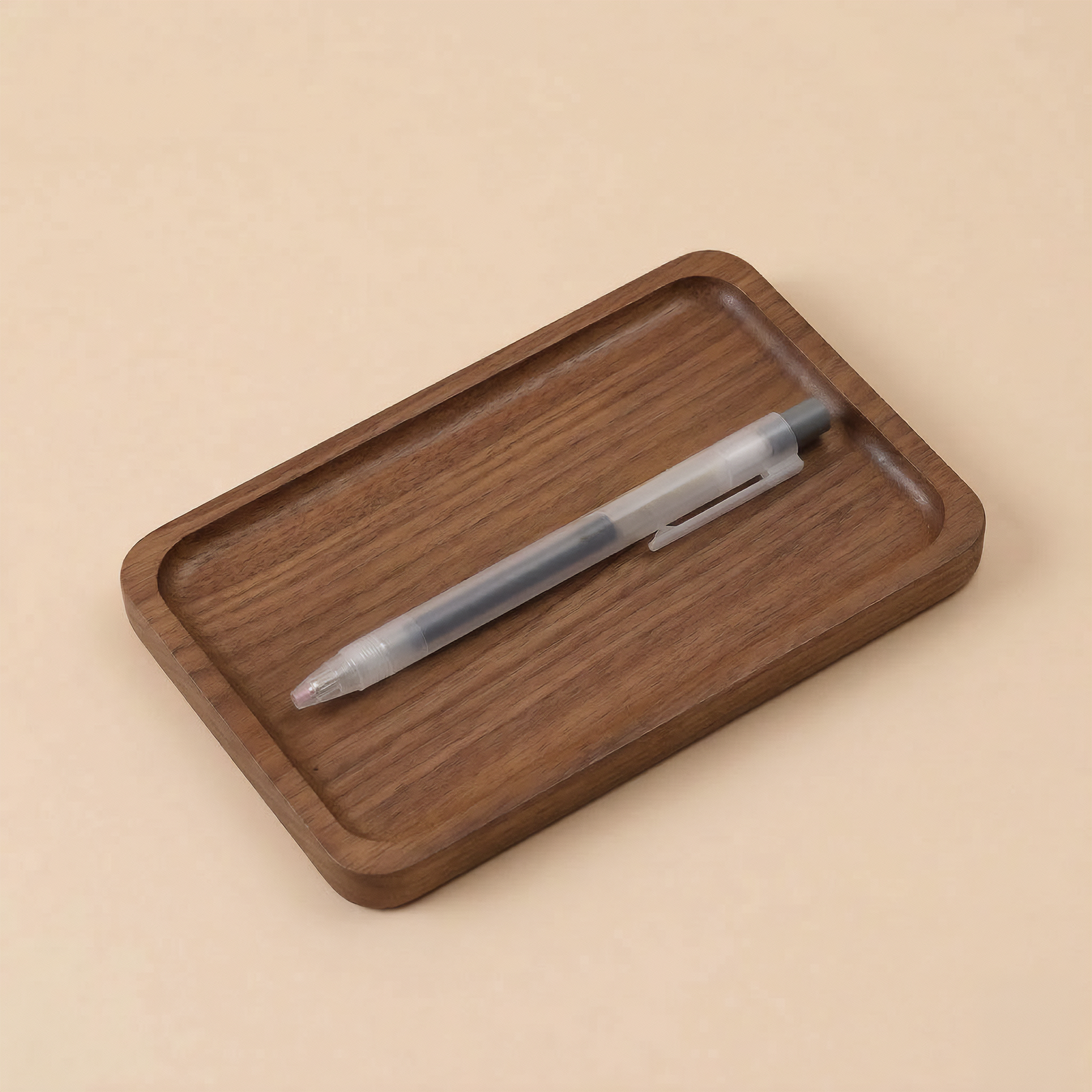 Wooden tray with a pen on a beige background