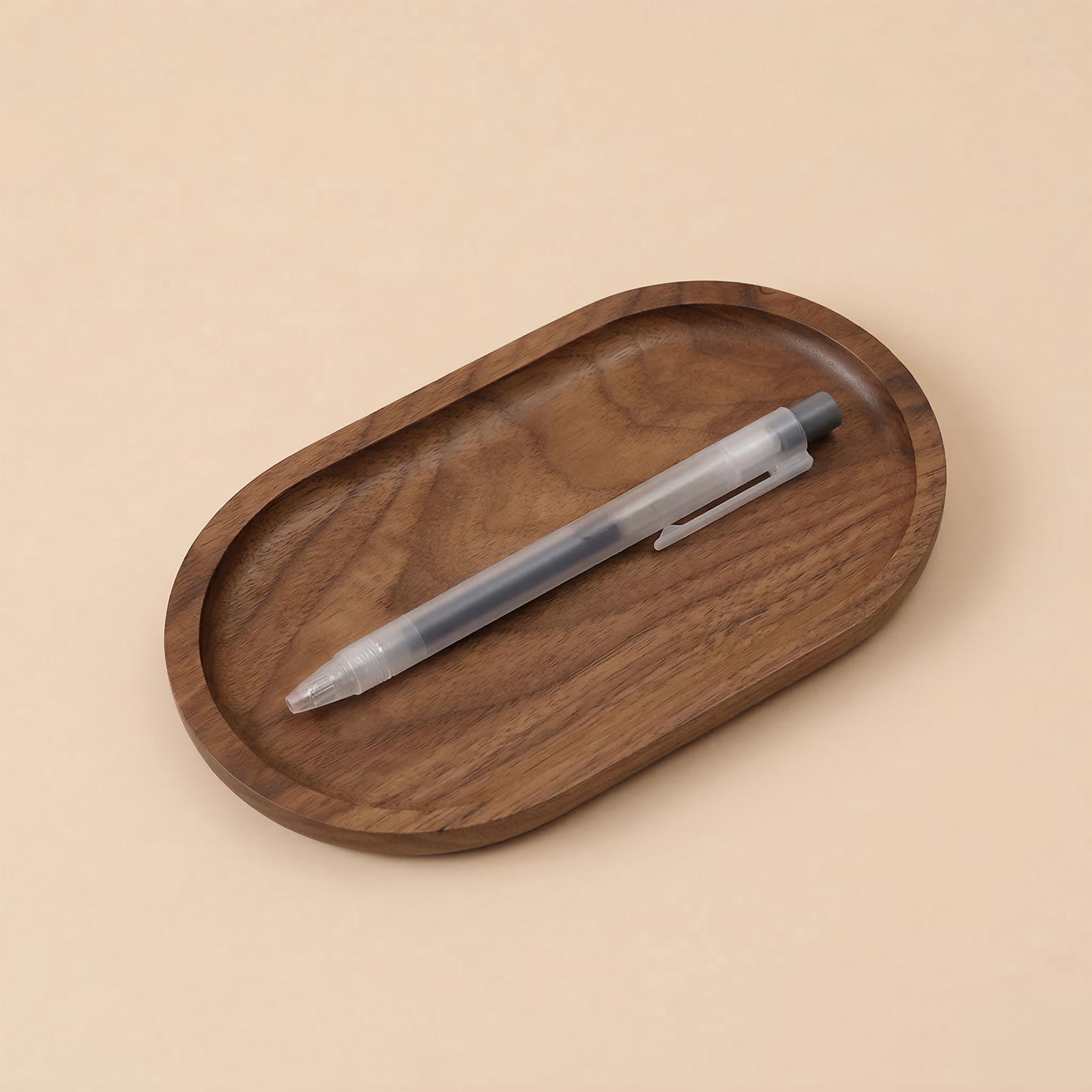 Wooden tray with a pen on a beige background