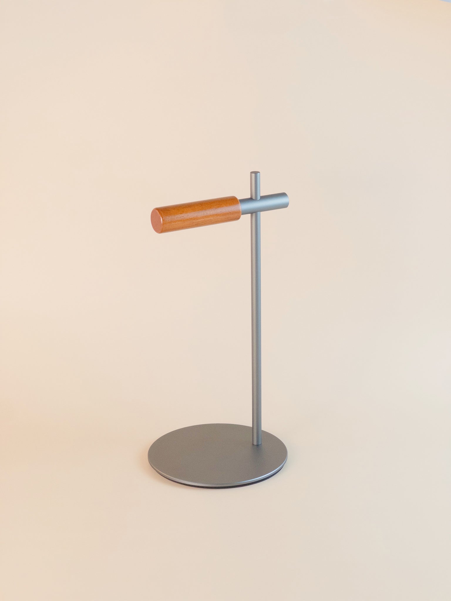 Modern grey aluminum headphone stand with wooden support bar