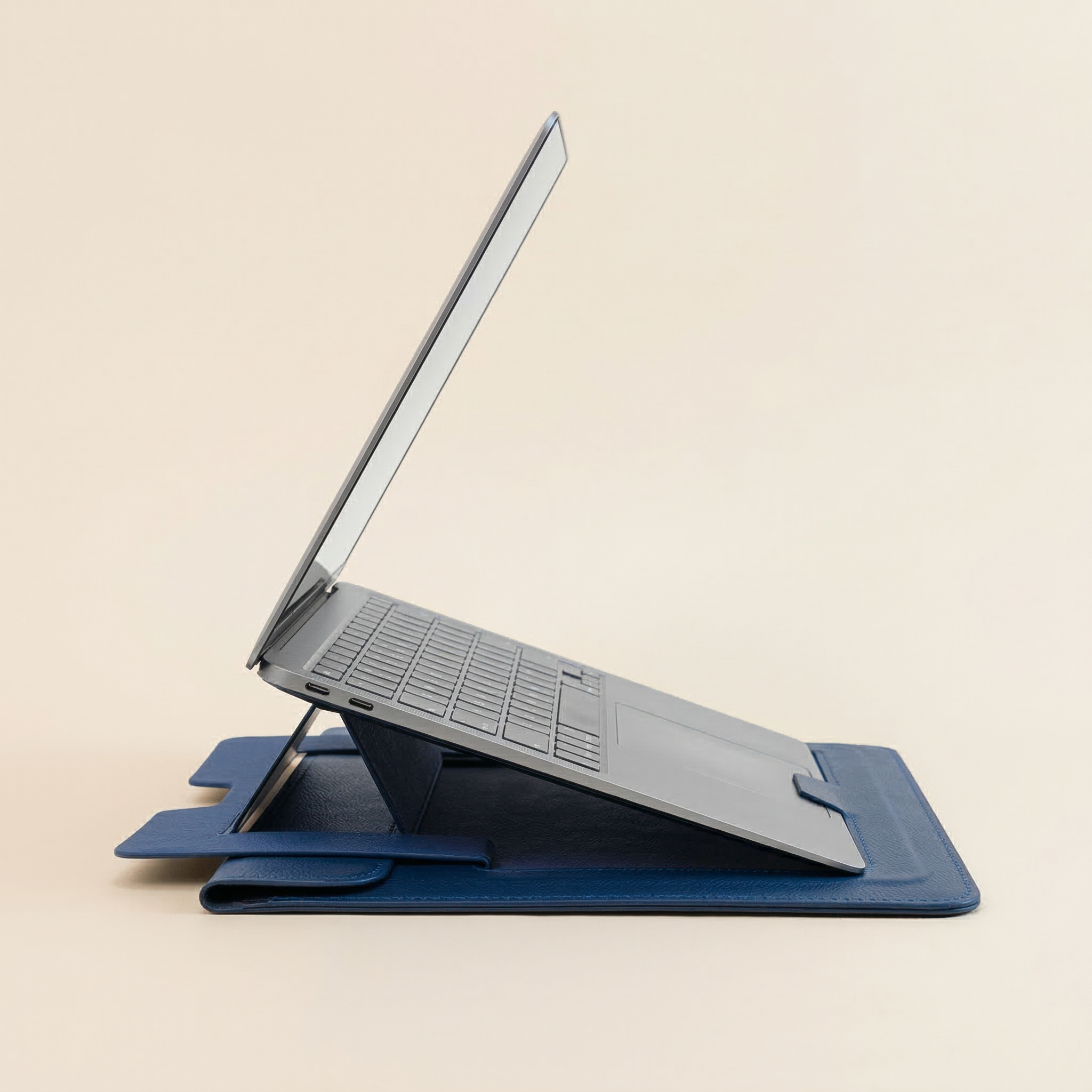 Laptop on a blue stand against a beige background
