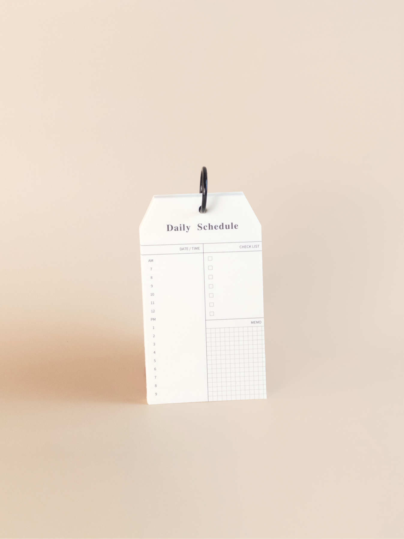 White daily schedule notepad with black text on a beige background
