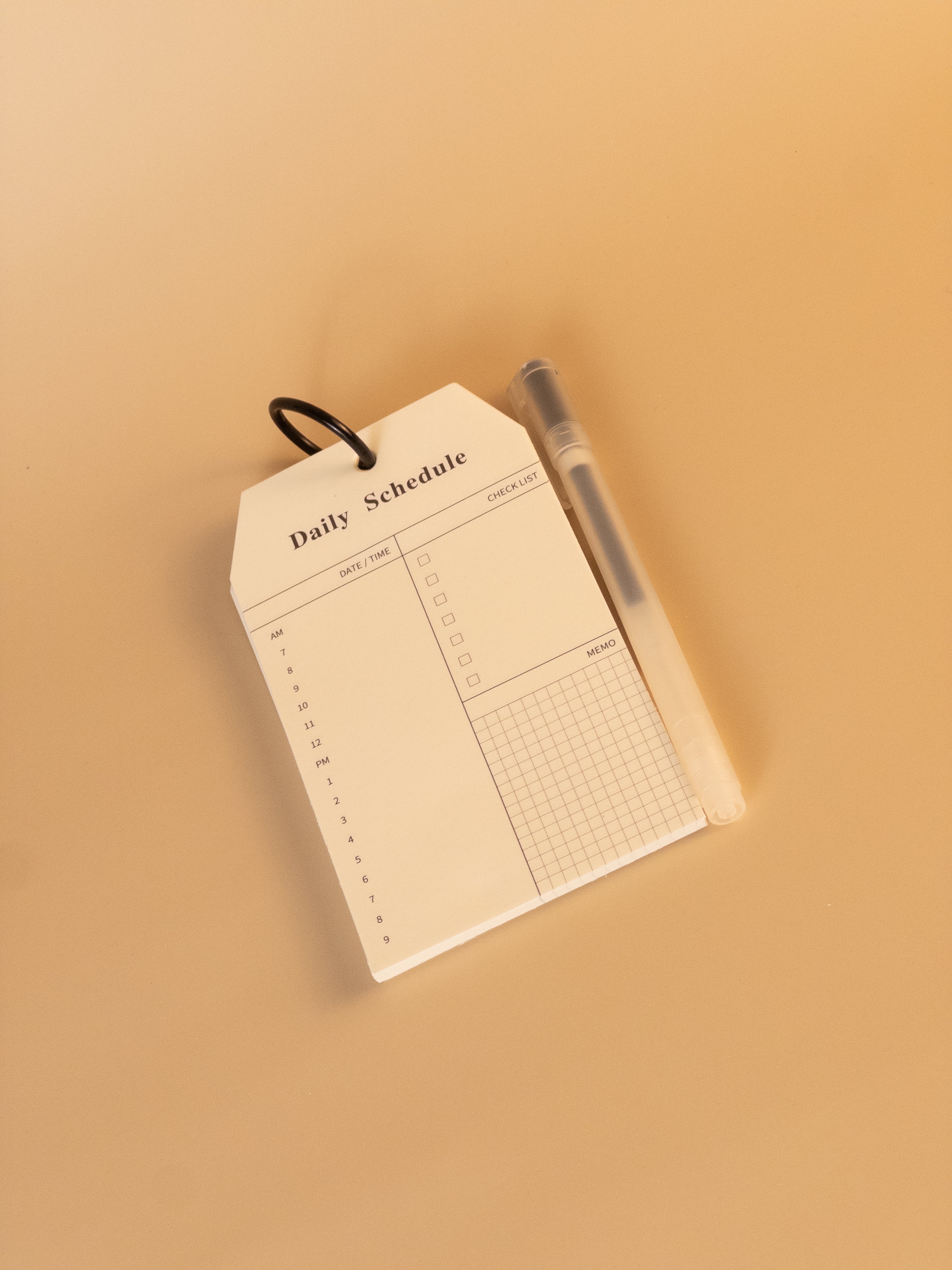 Daily schedule notepad with ring binding and pen for daily planning