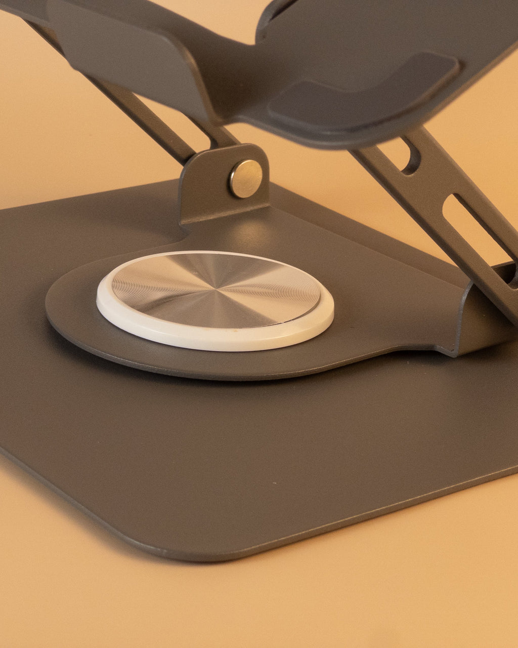 gray adjustable laptop stand on a beige background