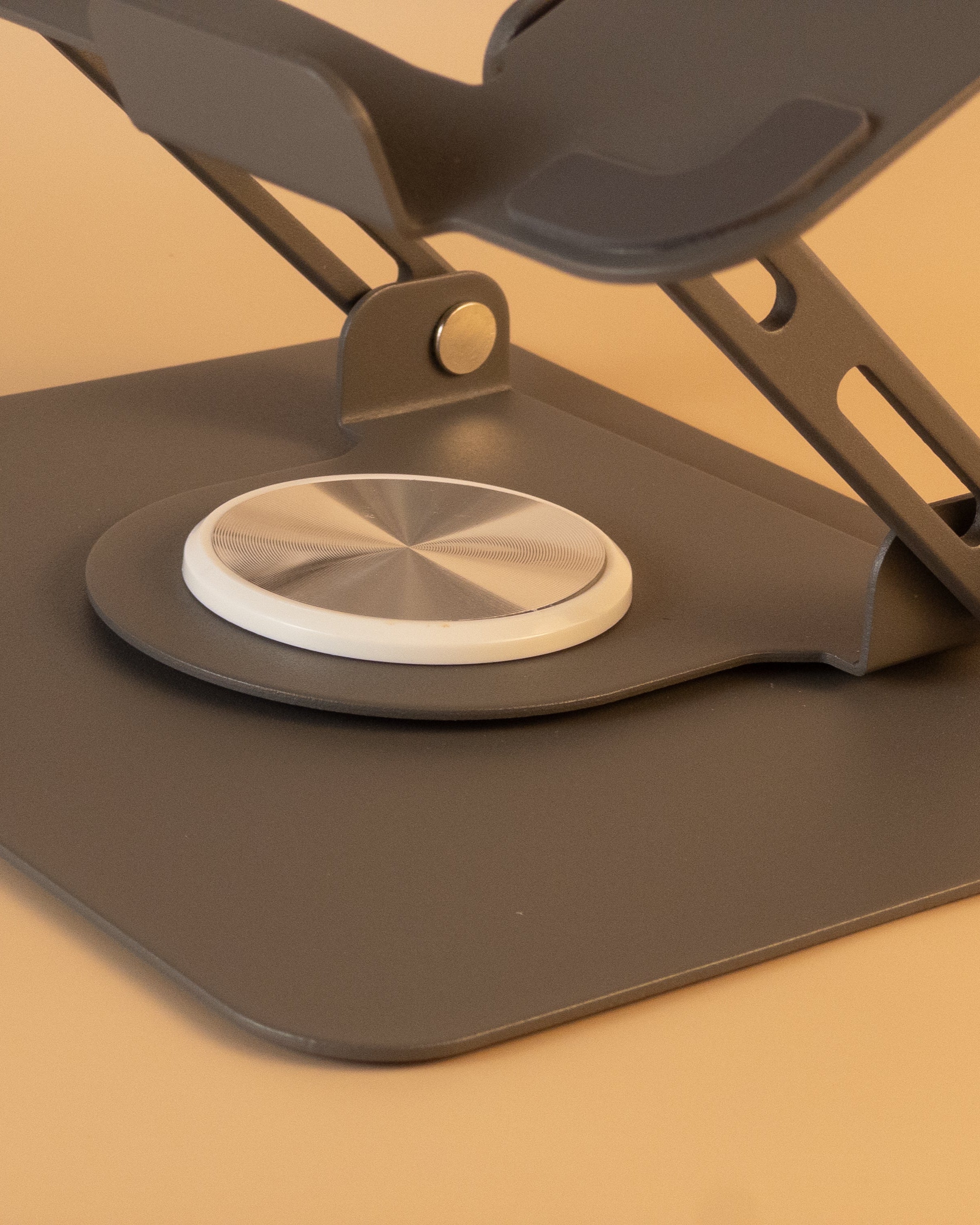 gray adjustable laptop stand on a beige background