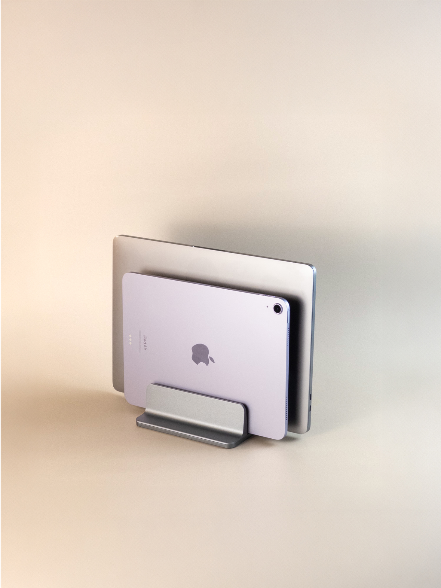 Two devices stacked on a vertical stand with a gradient background