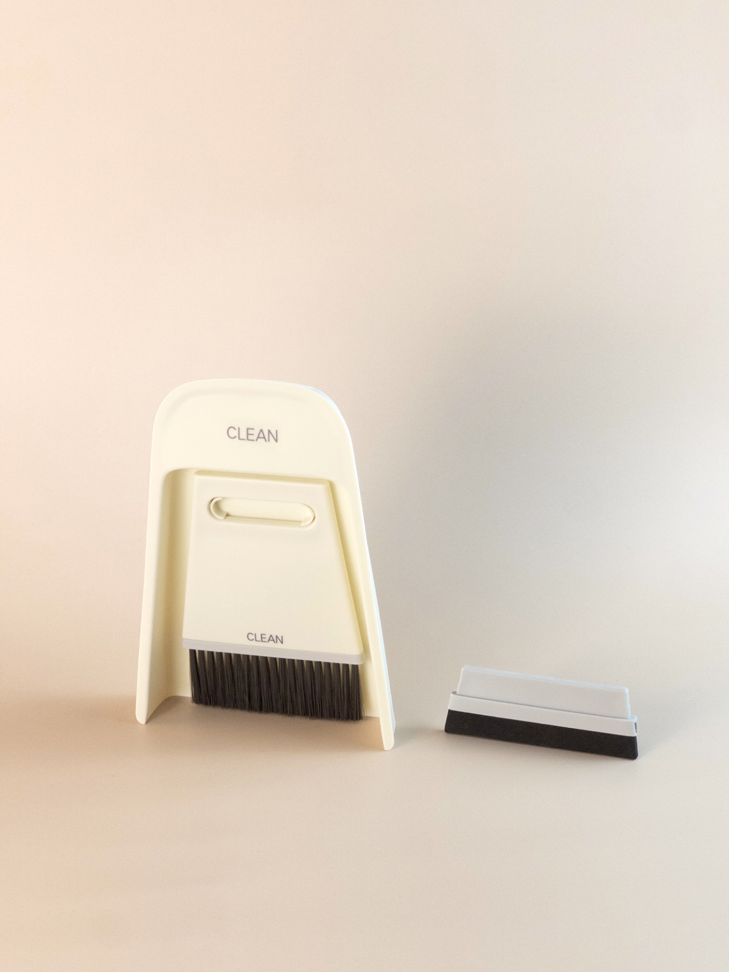 White desktop cleaning brush set with compact bristles and matching dustpan, ideal for keeping desks tidy.