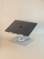 Laptop on a stand with a plain background