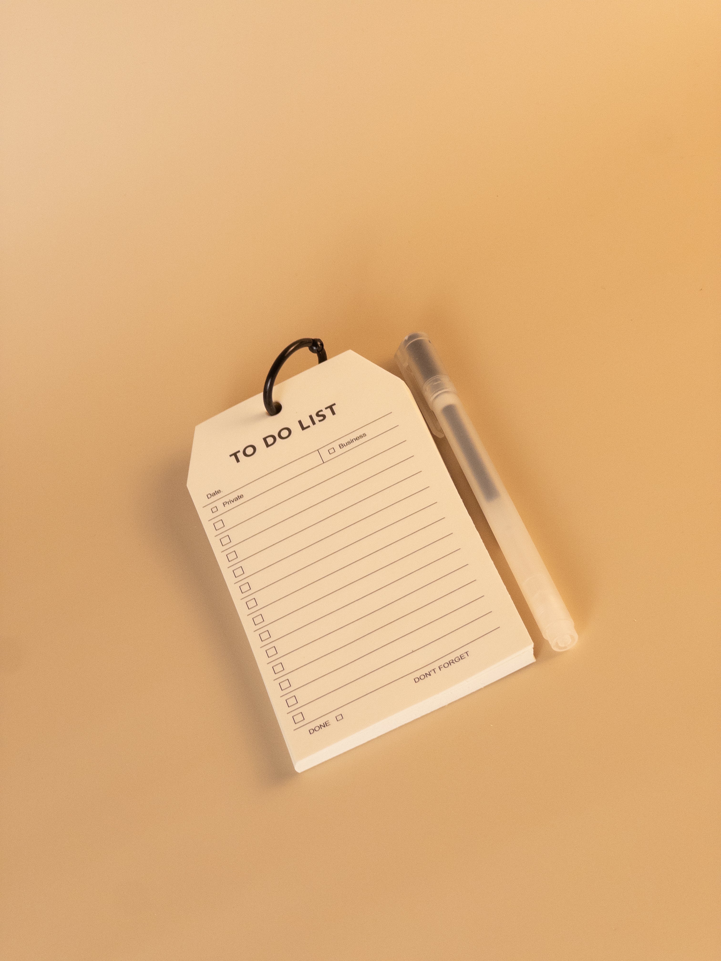 To do list notepad with black ring and pen for planning tasks